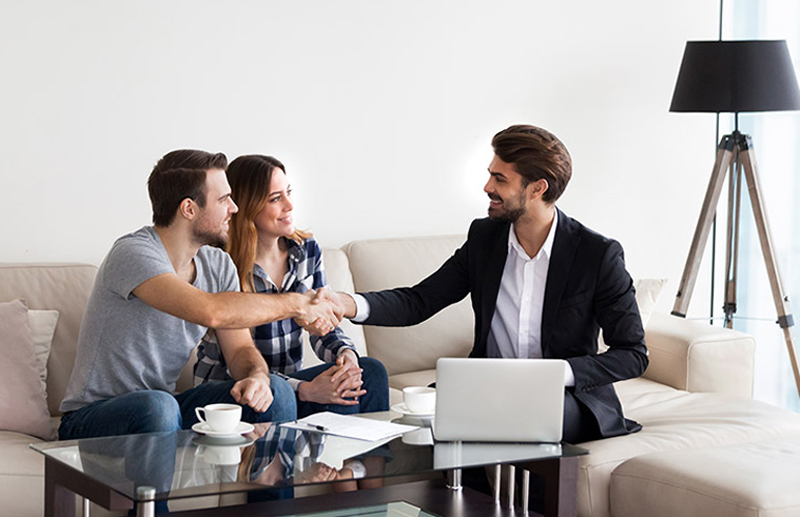 Image shows happy landlord shaking hands with happy tenants - protect your rental investment with our landlord insurance.